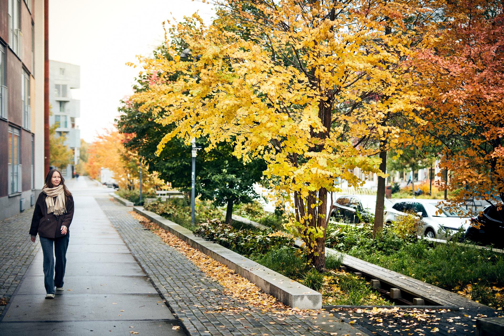 Woman walking next to a building